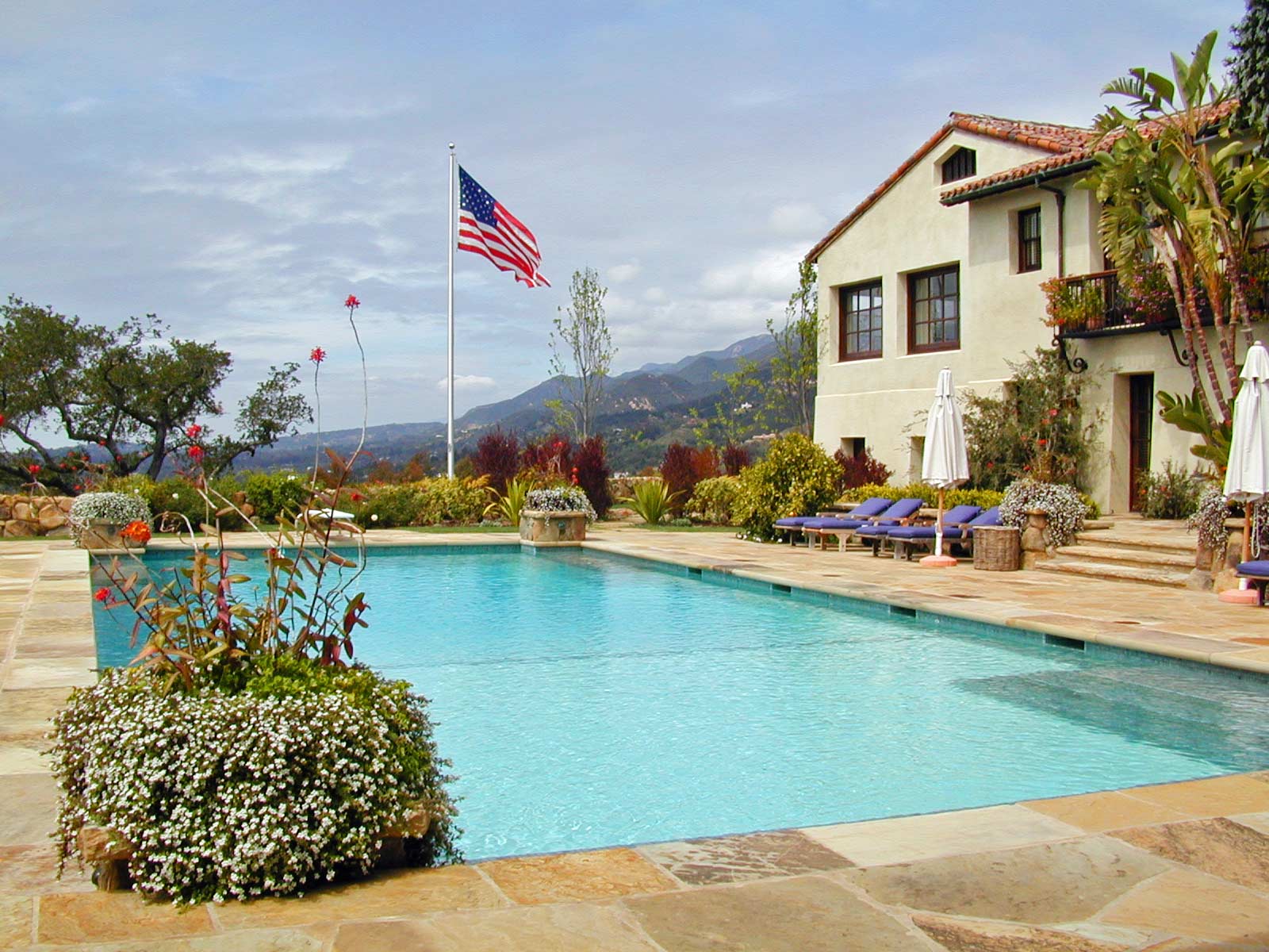 Estate pool in yard with flagpole